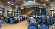 A full church listening to a poem while the choir have a break