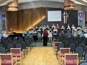 Intern Phoebe Wright rehearsing the choir