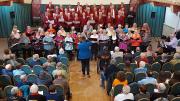 Tom Newall conducting both choirs